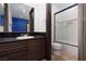 Bathroom features dark wood cabinets, granite counters, and tub/shower combo at 2215 Alcova Ridge Dr, Las Vegas, NV 89135