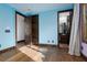 Bedroom featuring hardwood floors, blue walls, and a view into the Primary bath at 2215 Alcova Ridge Dr, Las Vegas, NV 89135