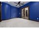 Large bedroom featuring blue walls and access to outdoor courtyard via glass doors at 2215 Alcova Ridge Dr, Las Vegas, NV 89135