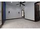 Spacious bedroom features plush carpeting, ceiling fan, neutral walls and dark trim at 2215 Alcova Ridge Dr, Las Vegas, NV 89135