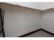 Walk-in closet featuring carpet floors, wood baseboards, and closet rod for hanging clothes at 2215 Alcova Ridge Dr, Las Vegas, NV 89135