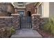 Elegant stone front gate leading to the main entrance, offering privacy and security, with decorative lighting at 2215 Alcova Ridge Dr, Las Vegas, NV 89135