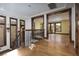 Grand hallway with elegant wood floors, staircase and wrought iron railing, and wood trim at 2215 Alcova Ridge Dr, Las Vegas, NV 89135