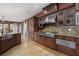 Open-concept kitchen featuring granite counters, stainless appliances, and hardwood floors at 2215 Alcova Ridge Dr, Las Vegas, NV 89135