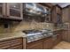 Gourmet kitchen with stainless-steel range and custom cabinetry, illuminated by modern lighting at 2215 Alcova Ridge Dr, Las Vegas, NV 89135