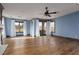 Living room boasts hardwood floors, large windows with white curtains, and access to outdoor balcony at 2215 Alcova Ridge Dr, Las Vegas, NV 89135