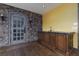 Entertainers wet bar featuring beautiful stonework and a custom door with a complementing wooden vanity at 2215 Alcova Ridge Dr, Las Vegas, NV 89135