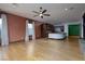 Open-concept living room with a kitchen, fireplace, large windows, and a ceiling fan at 2215 Alcova Ridge Dr, Las Vegas, NV 89135