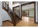 Spacious living room with hardwood floors, large windows, and a grand staircase nearby at 2215 Alcova Ridge Dr, Las Vegas, NV 89135
