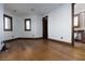 Sunlit living room with hardwood floors and entryways to bathroom and hallway at 2215 Alcova Ridge Dr, Las Vegas, NV 89135