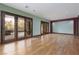 Expansive living room with hardwood floors and outdoor access through French doors to a patio at 2215 Alcova Ridge Dr, Las Vegas, NV 89135