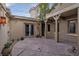 Inviting patio area with stone flooring, lush greenery, and elegant lighting for outdoor enjoyment at 2215 Alcova Ridge Dr, Las Vegas, NV 89135
