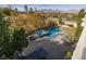 An aerial view of the backyard pool and spa with the golf course and mountains beyond at 2215 Alcova Ridge Dr, Las Vegas, NV 89135