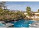 Relaxing backyard pool with lush landscaping and mountain views offers a private oasis at 2215 Alcova Ridge Dr, Las Vegas, NV 89135