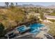 Inviting backyard featuring a sparkling pool, spa, and mountain views, perfect for outdoor relaxation and entertainment at 2215 Alcova Ridge Dr, Las Vegas, NV 89135