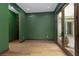 Cozy room with hardwood floors, olive walls, and French doors to a courtyard at 2215 Alcova Ridge Dr, Las Vegas, NV 89135
