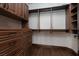 Custom built in walk-in closet includes drawers, shelving, and hanging storage with wood base trim at 2215 Alcova Ridge Dr, Las Vegas, NV 89135