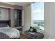 Stylish bedroom featuring built-in closet and floor-to-ceiling window with bench seating overlooking the city at 222 Karen Ave # 3104, Las Vegas, NV 89109
