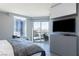 Bright bedroom featuring a balcony with city views and a sleek entertainment center at 222 Karen Ave # 3104, Las Vegas, NV 89109