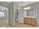 Bathroom with double sink, tile flooring, and shower featuring a partial view of the bedroom at 2256 Cordaville Dr, Henderson, NV 89044