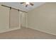 Bedroom showcases wood look sliding door, neutral paint, tile flooring and ceiling fan at 2256 Cordaville Dr, Henderson, NV 89044