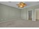 Bedroom boasts neutral carpet, ceiling fan, and an open doorway to the en-suite bathroom at 2256 Cordaville Dr, Henderson, NV 89044
