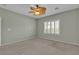 Comfortable bedroom featuring neutral carpeting, shuttered windows, and decorative ceiling fan at 2256 Cordaville Dr, Henderson, NV 89044