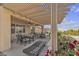 View of the covered patio with desert landscaping and wrought iron dining set at 2256 Cordaville Dr, Henderson, NV 89044