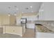 Bright kitchen with stainless appliances, island, and white cabinets at 2256 Cordaville Dr, Henderson, NV 89044