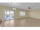 Bright living room with tile floors, ceiling fan, and sliding glass doors to the backyard at 2256 Cordaville Dr, Henderson, NV 89044
