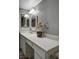 A long bathroom counter with storage is enhanced by two mirrors and modern lighting at 2300 E Silverado Ranch Blvd # 1123, Las Vegas, NV 89183