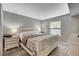 This bedroom has a queen bed, gray paint, grey carpet, and a large window with natural light at 2300 E Silverado Ranch Blvd # 1123, Las Vegas, NV 89183