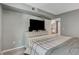 Bedroom view showcases a TV, wood-look floors, and closet access at 2300 E Silverado Ranch Blvd # 1123, Las Vegas, NV 89183