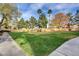 Expansive greenspace with trees, shrubs, and paved walkway for walking at 2300 E Silverado Ranch Blvd # 1123, Las Vegas, NV 89183