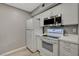 Bright kitchen featuring modern white appliances, white countertops, and hardwood-style flooring at 2300 E Silverado Ranch Blvd # 1123, Las Vegas, NV 89183