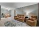 Spacious living room featuring hardwood-style floors, a ceiling fan, and comfortable leather furniture at 2300 E Silverado Ranch Blvd # 1123, Las Vegas, NV 89183