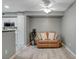 Cozy living room with a small sofa and a view into the kitchen featuring hardwood-style floors at 2300 E Silverado Ranch Blvd # 1123, Las Vegas, NV 89183