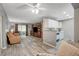 Bright living room with hardwood-style floors, a ceiling fan, and direct access to the kitchen at 2300 E Silverado Ranch Blvd # 1123, Las Vegas, NV 89183