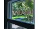 The window offers a peaceful view of trees, grass, and the building at 2300 E Silverado Ranch Blvd # 1123, Las Vegas, NV 89183