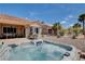 Relax in this backyard oasis with a hot tub and a built-in barbecue grill at 2305 Hot Oak Ridge St, Las Vegas, NV 89134