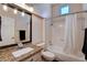 Bathroom with a tub and shower combination, granite countertop, and neutral color palette at 2305 Hot Oak Ridge St, Las Vegas, NV 89134