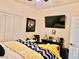 Cozy bedroom featuring a wall-mounted TV and shuttered closet doors at 2305 Hot Oak Ridge St, Las Vegas, NV 89134