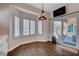 Bright dining area with patio access and modern decor, featuring stylish light fixture and tiled floors at 2305 Hot Oak Ridge St, Las Vegas, NV 89134
