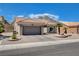 A well-maintained single-story home featuring a two-car garage and desert landscaping at 2305 Hot Oak Ridge St, Las Vegas, NV 89134