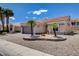 A charming single-story home features desert landscaping, a two-car garage, and a welcoming entrance at 2305 Hot Oak Ridge St, Las Vegas, NV 89134