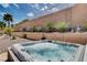 A hot tub with crystal clear water bubbles awaits in the landscaped backyard at 2305 Hot Oak Ridge St, Las Vegas, NV 89134