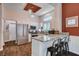 Bright kitchen featuring granite countertops, stainless appliances, and a center island with bar seating at 2305 Hot Oak Ridge St, Las Vegas, NV 89134