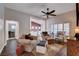 A well-lit living room with hardwood floors, comfortable seating, and views of the kitchen and office at 2305 Hot Oak Ridge St, Las Vegas, NV 89134