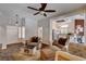 Bright living room features comfortable seating, a ceiling fan, and an open view into the kitchen at 2305 Hot Oak Ridge St, Las Vegas, NV 89134