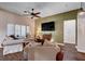 Cozy living room with neutral tones, a ceiling fan, TV, and comfortable seating arrangement at 2305 Hot Oak Ridge St, Las Vegas, NV 89134